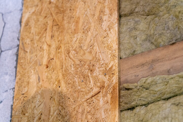 Half Wall Showcases Skillful Affixing of OSB Plate, Half Adorns Insulating Mineral Wool.