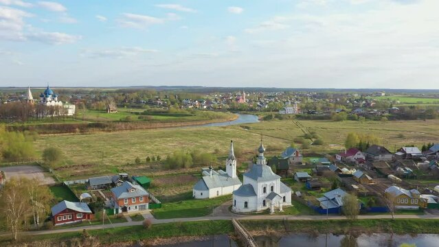 Scenic view of Suzdal city with churches, river and fields. Famous travel destination in Russia