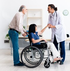 Old couple visiting young male doctor