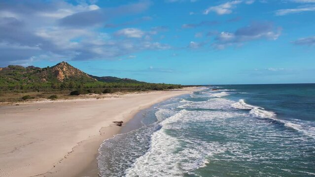 Aerial drone view on white sand Berchida beach of Sardegna. Warm turquoise sea and long beach on the Sardinia island.