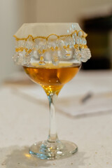 a glass bowl filled with oil with a veil covering