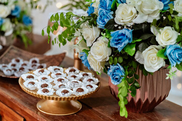 wooden table decorated with sweets and flowers