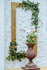 white wall with a wooden frame and flower decorations