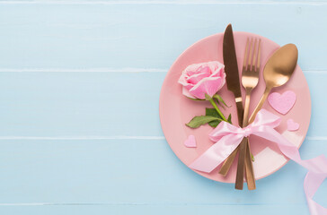 Festive table setting for Valentine's Day on wooden background, top view