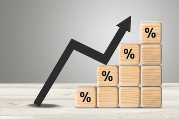 Wooden blocks with percentage signs, represent rate increase, sales increase