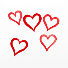 Five hearts drawn with lipstick on paper.