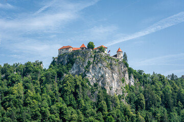 Glad Bled on top of a rock surrounded by forest above a clear blue sky, Slovenia, Bled