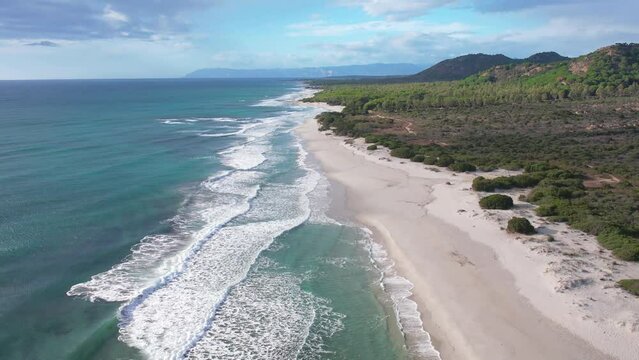 Aerial drone view on white sand Berchida beach of Sardegna. Warm turquoise sea and long beach on the Sardinia island.