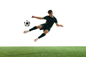 Young man, soccer player in black uniform, hitting ball in a jump, playing isolated over white...