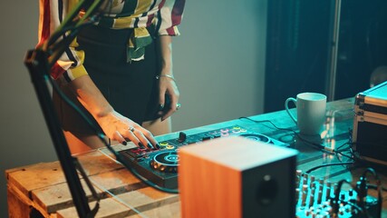 Woman artist using stereo discs and amplifier to play songs at club party, mixing electronic vinyl...