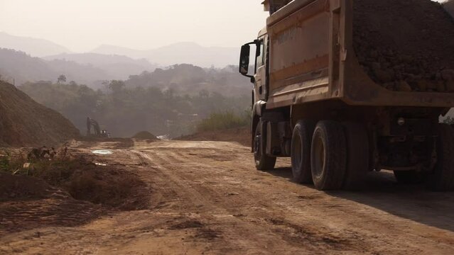 A truck drives along a dirt road in Africa