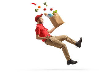 Delivery man with a grocery bag tumbling and falling