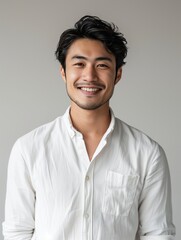 Portrait of young handsome Asian man smiling and looking camera with confidence.