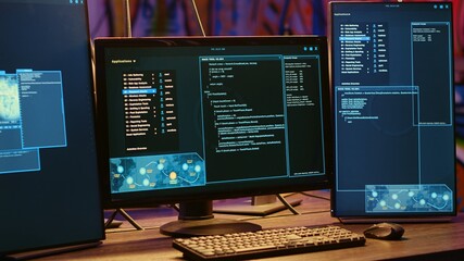 Close up shot on computer screens with hacking lines of code in secret underground bunker. PC...