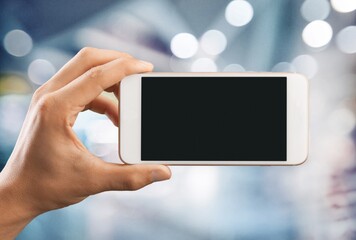 Human hand hold a smartphone with blank screen