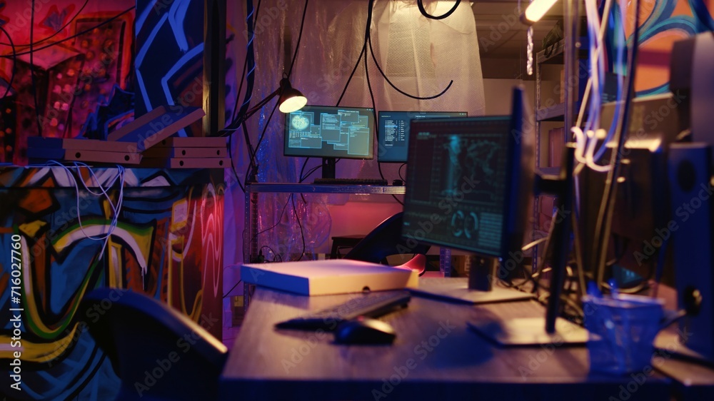 Aufkleber dolly out shot of empty messy hackers base of operations with neon lights and graffiti drawings spra