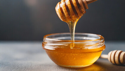 Golden honey drips from a dipper, symbolizing health and sweetness, a tempting visual of natural goodness - obrazy, fototapety, plakaty