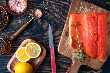 fresh raw organic salmon on dark wooden background, top view