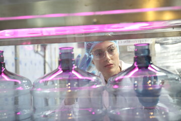 Team worker produces drinking water in a clean drinking water plant. drinking water production line