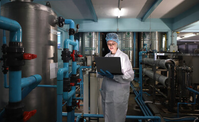 Team worker produces drinking water in a clean drinking water plant. drinking water production line