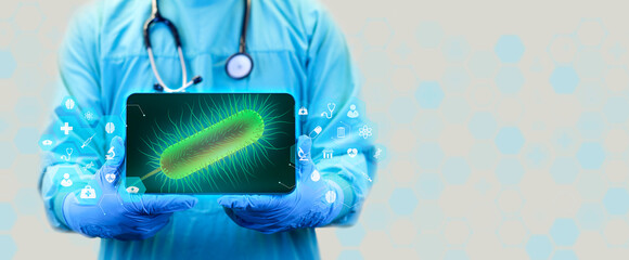 Doctor analyzes the image of Escherichia coli on his tablet. Concept of stomach diseases, diarrhea....