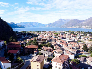 Fototapeta na wymiar The Italian valley of Lake Como among the picturesque foggy peaks of the Alps. 