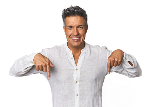 Middle-aged Latino man points down with fingers, positive feeling.