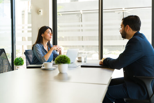Profile view of a woman talking to a job candidate during an interview