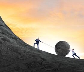 Teamwork example with business people pushing stone to top