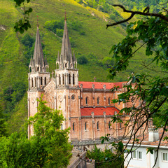 Fototapeta na wymiar View of majestic neo-romanesque temple - Basilica of Blessed Virgin Mary in valley of Covadonga, Asturias, Spain..