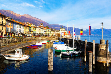 Buildings and boats along lakeshore in Cannobio, Piedmont, Italy. Lake Maggiore embankment.