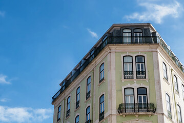 Obraz premium Light green colored apartment builiding in Lisbon, Portugal under sunny skies