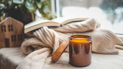 Burning candle in a cozy home interior