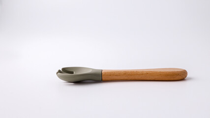 Silicone spoon for first feeding on a white background, side view