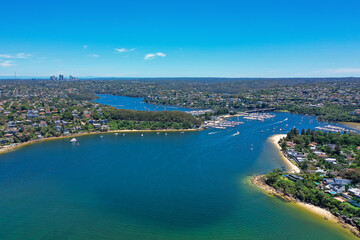High angle aerial drone view of Spit Bridge, Clontarf Beach and Sandy Bay in the suburb of Clontarf, Sydney, New South Wales, Australia. Northern Beaches area of Sydney and Chatswood in background.