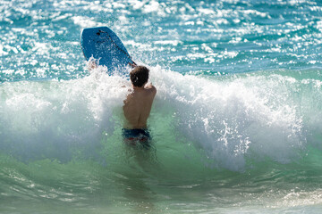 boogie boarding and playing in the water at Poipu beach