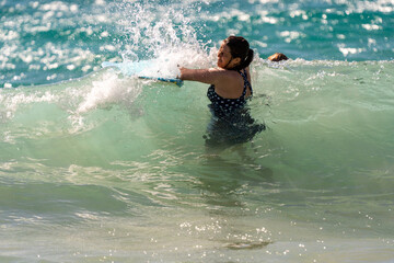 boogie boarding and playing in the water at Poipu beach