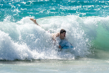 boogie boarding and playing in the water at Poipu beach