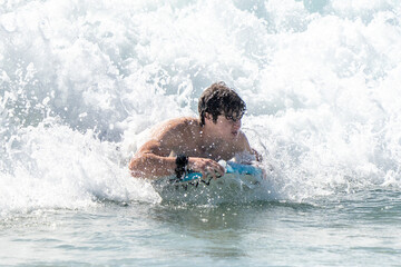 boogie boarding and playing in the water at Poipu beach