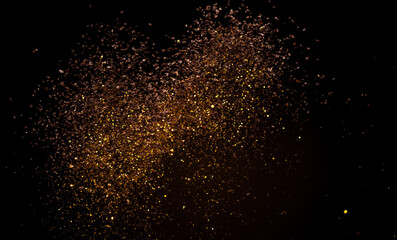 Fototapeta na wymiar Ground Coffee roasted powder dust fly explosion, Coffee crushed ground float pouring. Roasted Coffee powder ground dust splash explosion in mid Air. Black background Isolated gold bokeh