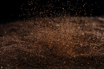 Ground Coffee roasted powder dust fly explosion, Coffee crushed ground float pouring. Roasted...