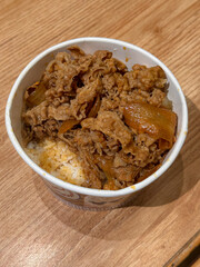 beef teriyaki and rice in paper bowl