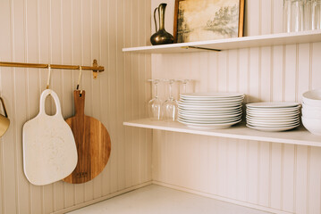 Organized Kitchen Shelf With Dishes and Utensils