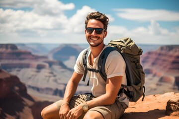 Fototapeta premium Male traveler with backpack on a scenic hike exploring dramatic canyon views
