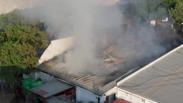 commercial building in a busy area in Gaborone, Africa , is burning down, aerial view