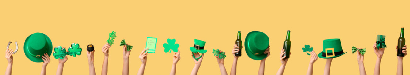 Many hands with beer, gifts and decor on yellow background. St. Patrick's Day celebration
