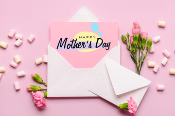 Envelopes, greeting card for Mother's Day, marshmallows and flowers on pink background, top view