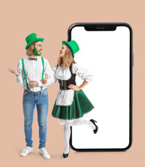 Young couple on white background. St. Patrick's Day celebration