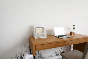 Stylish workplace near wall in room