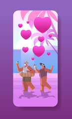 senior couple in love relaxing on beach old man woman lovers having fun active old age happy valentines day celebration concept
